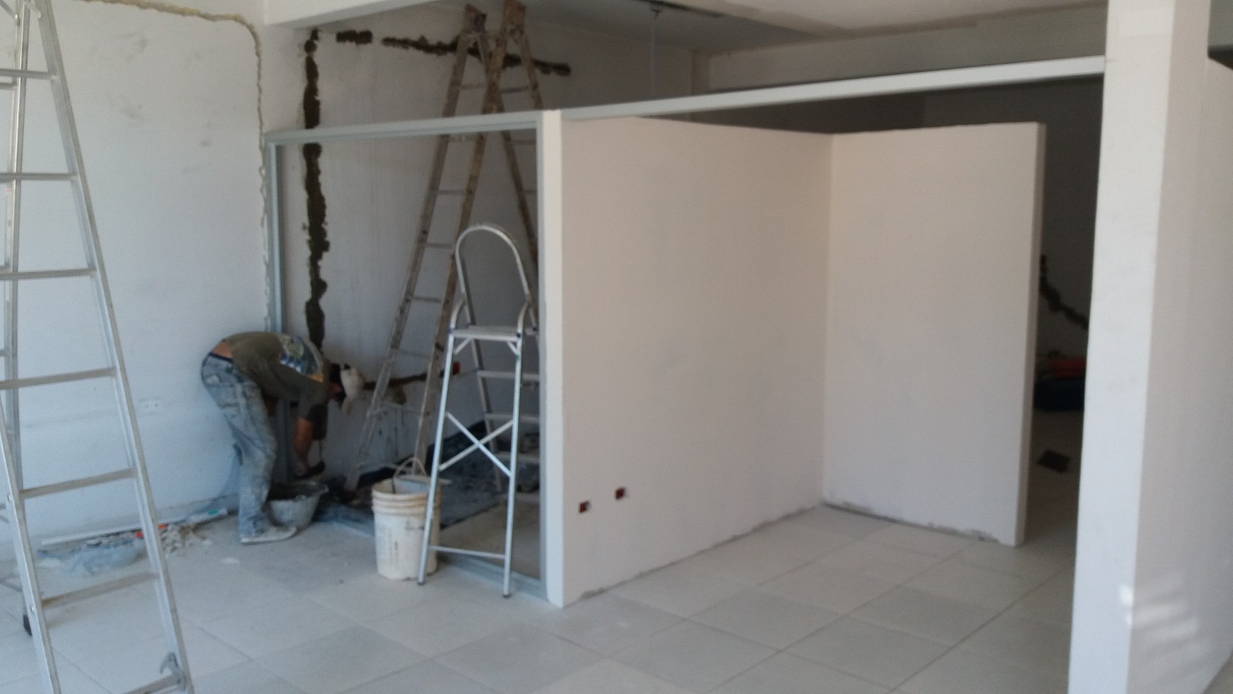 Tabiques de drywall levantados en un local en obra · MÁS VIDRIOS